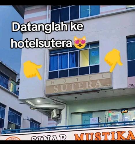 a sign on the side of a building at Hotel Sutera Maju in Kota Kinabalu