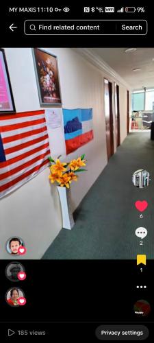 a picture of a hallway with an american flag at Hotel Sutera Maju in Kota Kinabalu