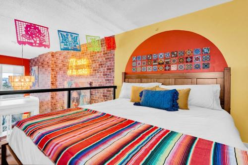 a bedroom with a bed with a colorful blanket at Casa DT Vancouver - Mexican Theme in Vancouver