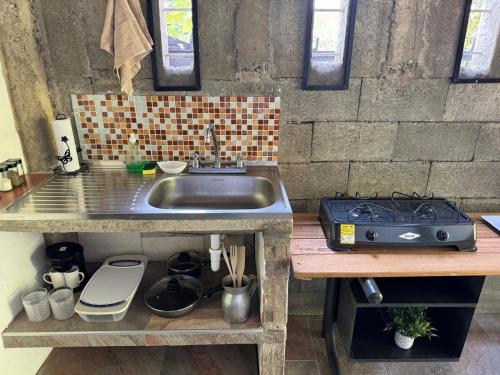 a kitchen with a sink and a counter top at Alojamiento campestre in Cali