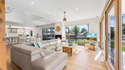 a living room with a couch and a table at Bendigo Lakeside in Eaglehawk
