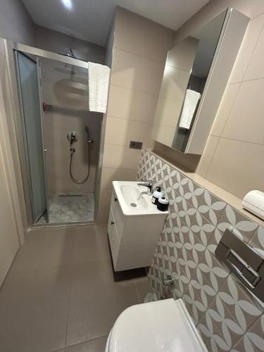 a bathroom with a toilet and a sink and a shower at Frezya Family Hotel in Istanbul