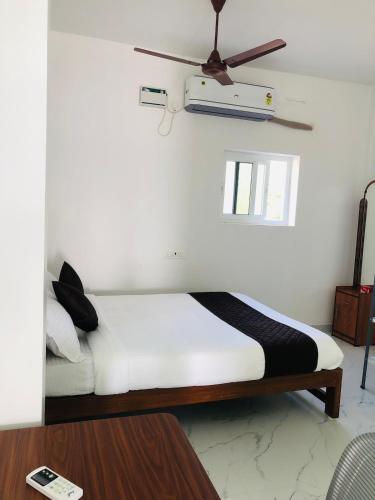 a bedroom with a bed with a ceiling fan at Virtus home stay in Pondicherry