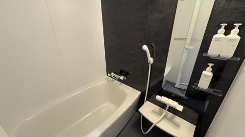 a bathroom with a white bath tub and a sink at Hotel Forest Echo 森のこだま