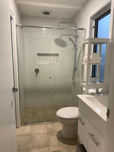 a bathroom with a glass shower and a toilet at Cosy Granny flat in Epping in Epping