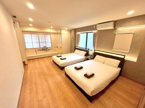 a large room with two beds and a bathroom at Skytree Luxury Villa - 2025 New, to Skytree, Direct Airport Access in Tokyo