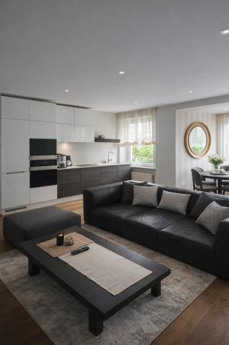 a living room with a black couch and a table at Downtown Boulevard View Residence in Šiauliai