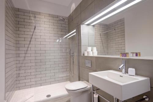a bathroom with a sink and a toilet and a shower at Destiny Scotland - Distillers House in Edinburgh