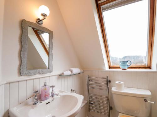 a bathroom with a sink and a toilet and a window at Inshcraig in Kincraig