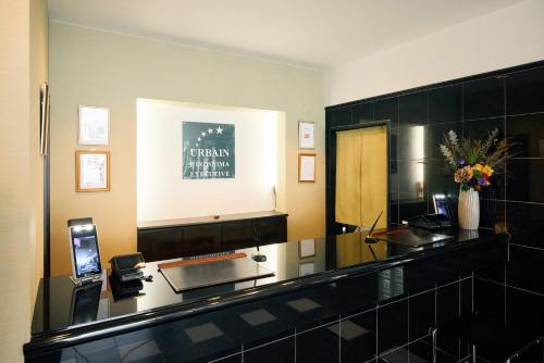 a hotel room with a reception desk and a mirror at Urbain Hiroshima Executive in Hiroshima