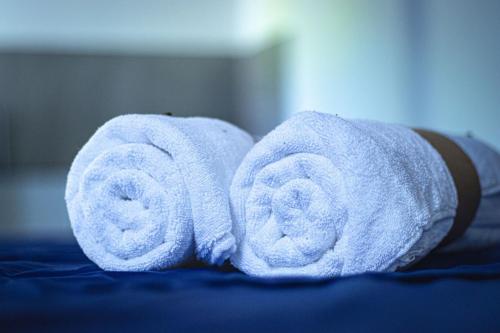two rolls of towels sitting on top of a bed at Ranketha Hideout Resorts in Kurunegala