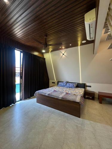 a bedroom with a large bed in a room at Celebrations Party House in Kolhapur