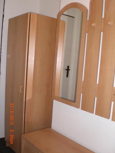 a wooden cabinet with a mirror on top of a box at Na 15 Kopách in Kolín