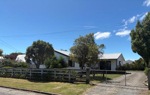 a house with a fence in front of it at Lockwood on Cologne in Martinborough