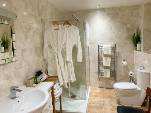 a bathroom with a shower and a sink and a toilet at The Fylde International Guest House in Blackpool