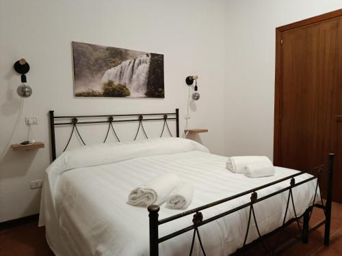 a bedroom with a bed with two towels on it at Hotel Panorama in Cerreto di Spoleto