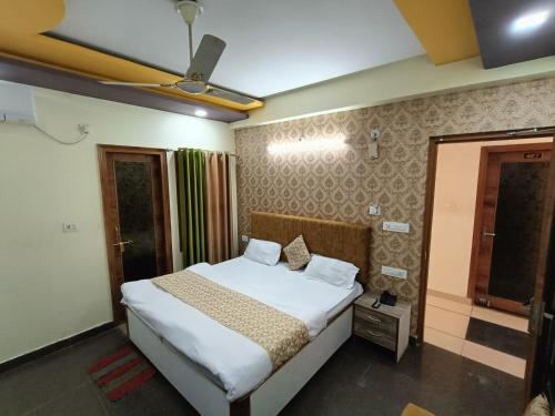 a bedroom with a bed and a ceiling at HOTEL AMAN in Allahābād