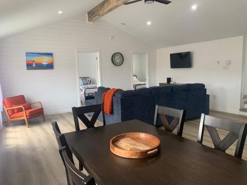 a living room with a table and a couch at Spiller's Cottage in Twillingate