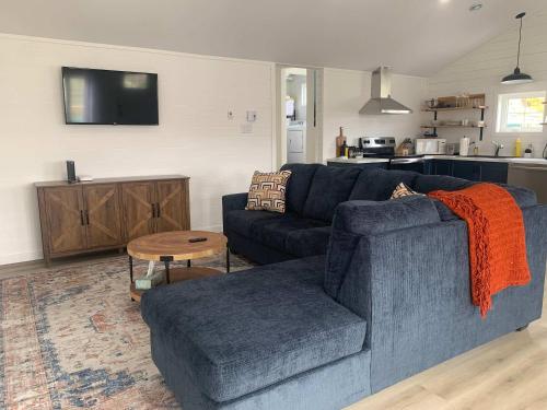 a living room with a blue couch and a table at Spiller's Cottage in Twillingate