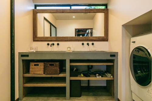 a bathroom with a sink and a mirror at Minato-no Akari in Hayama