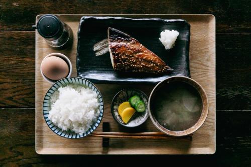 a tray of food with sushi and rice on a table at Minato-no Akari in Hayama