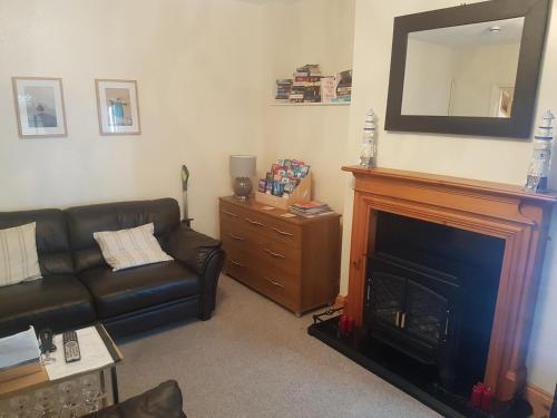 a living room with a couch and a fireplace at The Trelinda Guest House in Newquay