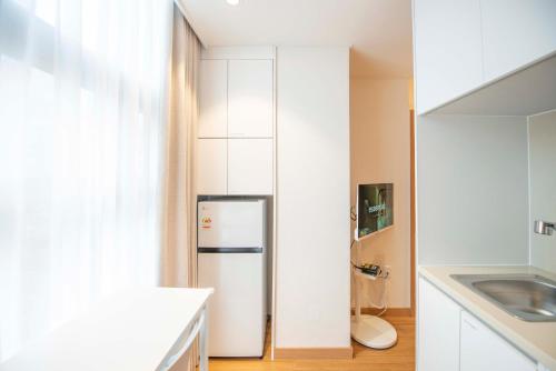 a kitchen with a refrigerator and a sink at akastay Myeongdong in Seoul
