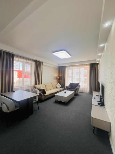 a living room with a couch and a table at Och Service Apartment in Ulaanbaatar