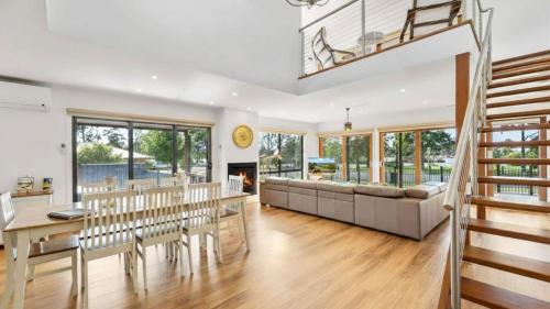 a living room with a couch and a table at Bendigo Lakeside in Eaglehawk