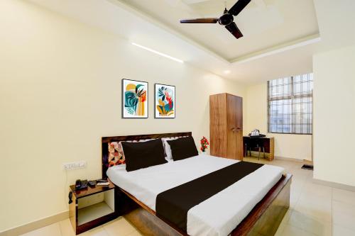 a bedroom with a bed and a ceiling fan at Collection O Ayodhya Ring Road Bhopal in Bhopal