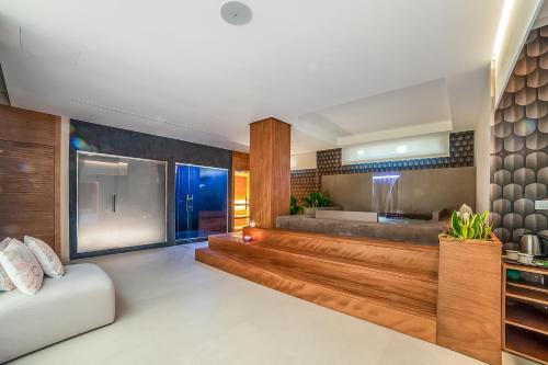a living room with a couch and a kitchen at 7 Bedroom Luxury Villa - Pool, Garden & Parking - Happy Rentals in Scorrano