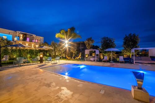 a swimming pool in a villa at night at 7 Bedroom Luxury Villa - Pool, Garden & Parking - Happy Rentals in Scorrano