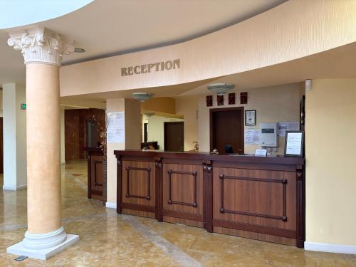 a lobby with a reception desk and a column at Hotel OTDIH in Kavarna