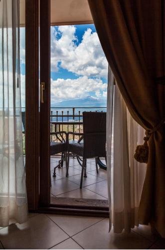 a room with a window with a view of the ocean at Villa Angela in Taormina