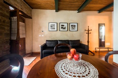 a living room with a table and a couch at il sogno di Tino in Cabernardi