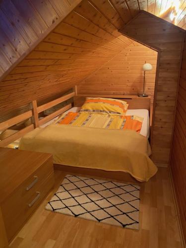 a bedroom with a bed in a wooden attic at Penzión - Tempo in Kremnica