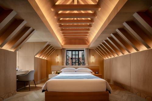 a bedroom with a large bed with wooden ceilings at ANHE GARDEN HOTEL in Shanghai