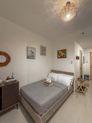 a bedroom with a large bed and a chandelier at Yugen Studio in Davao City