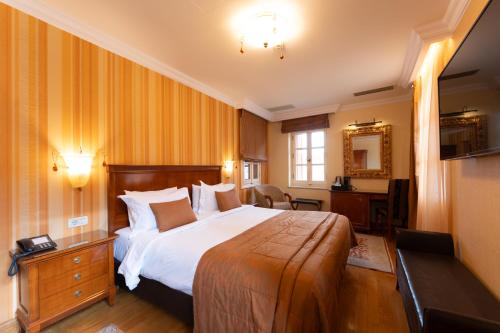 a hotel room with a bed and a desk at Aetoma Hotel in Nafplio