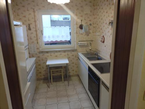 a small kitchen with a sink and a window at FEWO Stephan Grünewald in Gunzenhausen