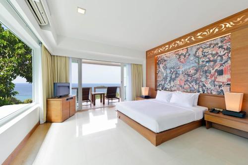 a bedroom with a bed and a large painting on the wall at SYLVAN Koh Chang in Ko Chang
