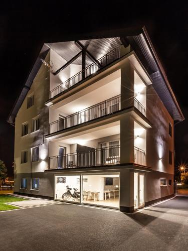 a large building with lights on it at night at Villa Milla in Łeba