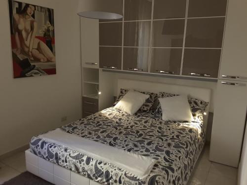 una camera da letto con un letto con un piumone bianco e nero di Casa dell'Artista a Salerno