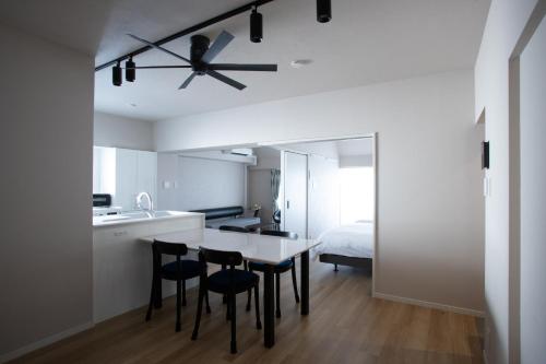 a kitchen and dining room with a ceiling fan at NIYS apartments 82type in Tokyo