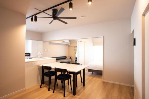 a kitchen and dining room with a ceiling fan at NIYS apartments 82type in Tokyo