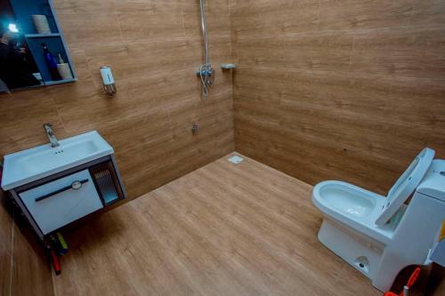 a bathroom with a white toilet and a sink at Nadyapartment in Dodoma