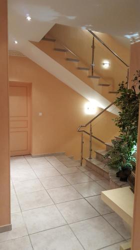 a living room with a staircase and a floor at Le Mas Champenois in Châlons-en-Champagne