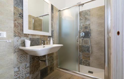 a bathroom with a sink and a shower at Timbuktu Hostel in San Vito lo Capo