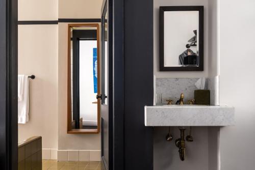 a bathroom with a sink and a mirror at Ace Hotel New York in New York