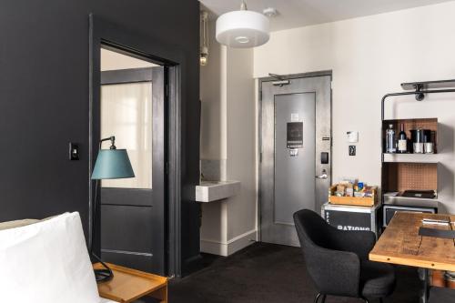 a room with a door and a table and chairs at Ace Hotel New York in New York